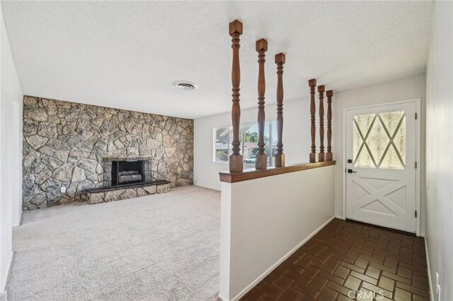 40389 Melrose Ave, Hemet, CA 92544 - foyer entrance featuring healthy amount of natural light, a textured ceiling, a fireplace, brick floors, and baseboards
