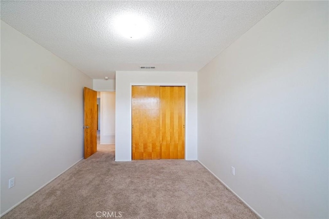 40389 Melrose Ave, Hemet, CA 92544 - unfurnished bedroom featuring carpet flooring, a closet, and a textured ceiling