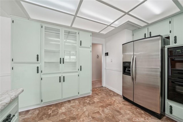 40389 Melrose Ave, Hemet, CA 92544 - kitchen with stainless steel refrigerator with ice dispenser, light countertops, stone finish flooring, and baseboards