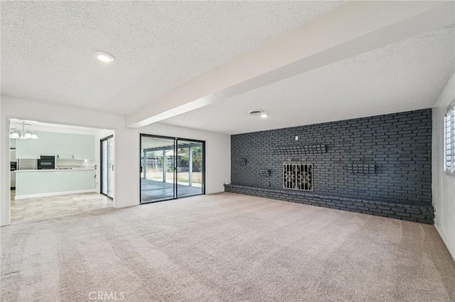 40389 Melrose Ave, Hemet, CA 92544 - unfurnished living room featuring a textured ceiling, a fireplace, carpet flooring, and brick wall