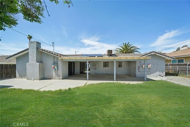 40389 Melrose Ave, Hemet, CA 92544 - back of property with solar panels, a patio area, central AC unit, stucco siding, and a chimney