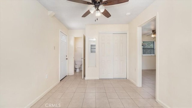 15820 E Queenside Dr, Covina, CA 91722 - unfurnished bedroom with light tile patterned flooring, baseboards, a closet, and ceiling fan