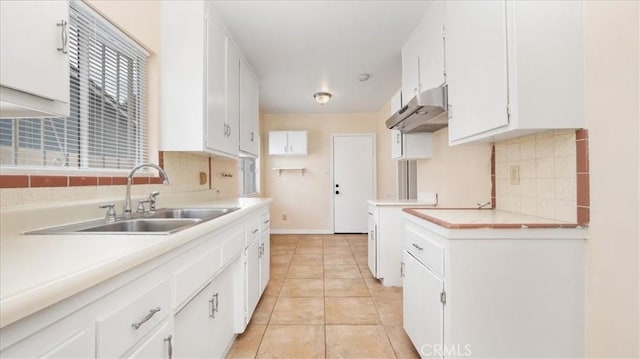 15820 E Queenside Dr, Covina, CA 91722 - kitchen with under cabinet range hood, a sink, tasteful backsplash, and white cabinetry