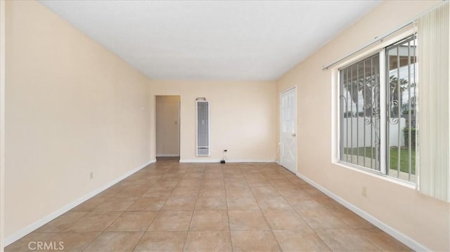 15820 E Queenside Dr, Covina, CA 91722 - empty room featuring a heating unit, baseboards, and light tile patterned floors