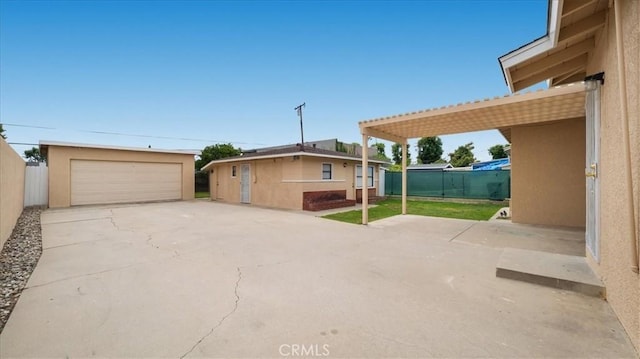 15820 E Queenside Dr, Covina, CA 91722 - view of home's exterior with a detached garage, an outdoor structure, fence, and stucco siding
