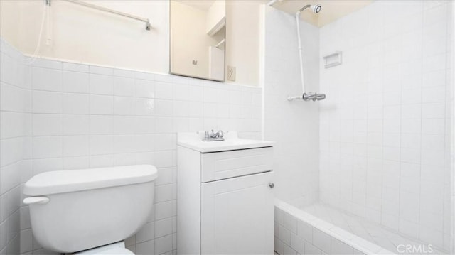 15820 E Queenside Dr, Covina, CA 91722 - full bath featuring tiled shower, tile walls, toilet, wainscoting, and vanity