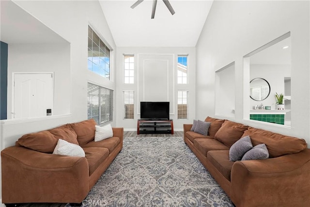 living room featuring high vaulted ceiling and a ceiling fan