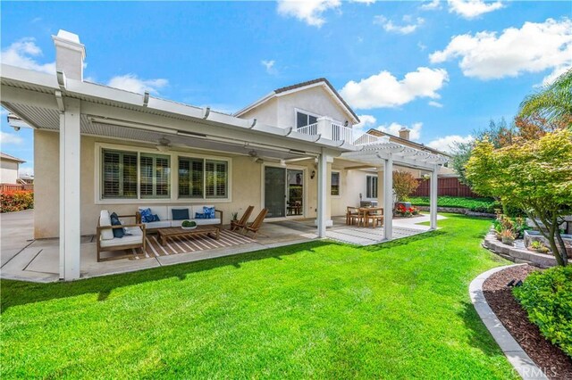 45133 Fieldbrook Ct, Temecula, CA 92592 - back of house with a pergola, ceiling fan, stucco siding, an outdoor living space, and a patio area