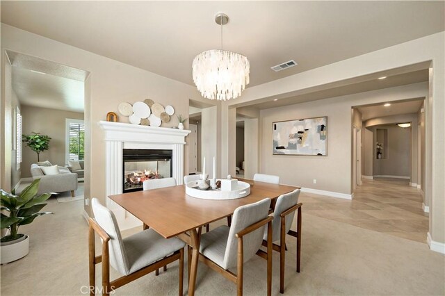 45133 Fieldbrook Ct, Temecula, CA 92592 - dining area featuring light colored carpet, baseboards, a multi sided fireplace, a chandelier, and recessed lighting