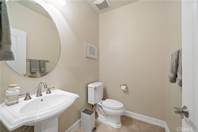 45133 Fieldbrook Ct, Temecula, CA 92592 - half bathroom featuring toilet, baseboards, tile patterned flooring, and a sink