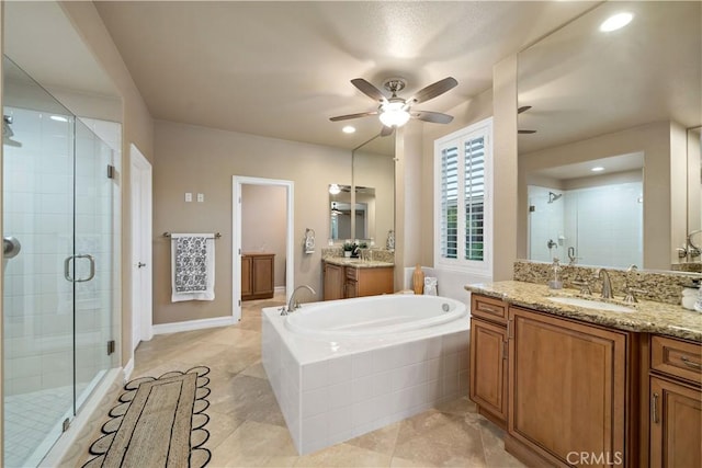 45133 Fieldbrook Ct, Temecula, CA 92592 - full bath with a stall shower, ceiling fan, a bath, two vanities, and recessed lighting