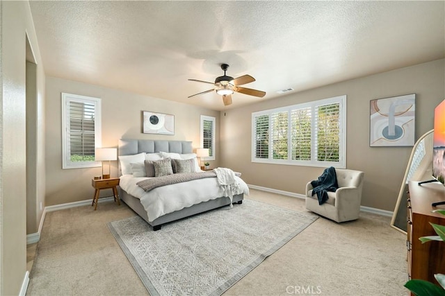 45133 Fieldbrook Ct, Temecula, CA 92592 - bedroom featuring light carpet, baseboards, ceiling fan, and a textured ceiling
