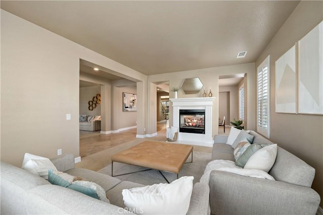 45133 Fieldbrook Ct, Temecula, CA 92592 - living area with a multi sided fireplace, baseboards, healthy amount of natural light, and carpet