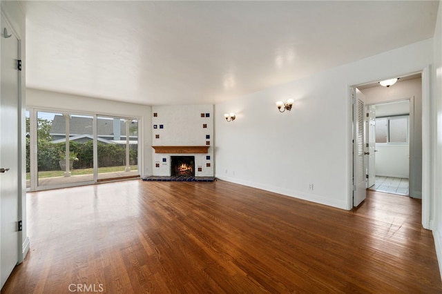 15408 Mottley Dr, La Mirada, CA 90638 - unfurnished living room featuring wood finished floors, a fireplace, and baseboards