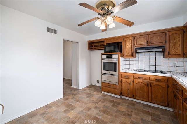 15408 Mottley Dr, La Mirada, CA 90638 - kitchen with oven, black microwave, under cabinet range hood, a warming drawer, and white electric cooktop