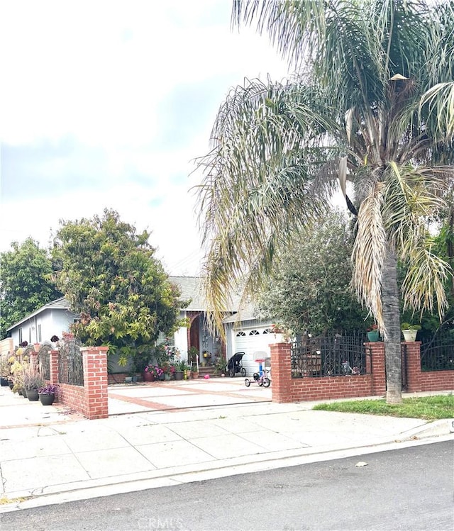 8900 Geyser Ave, Northridge, CA 91324 - obstructed view of property featuring a fenced front yard, concrete driveway, and a garage
