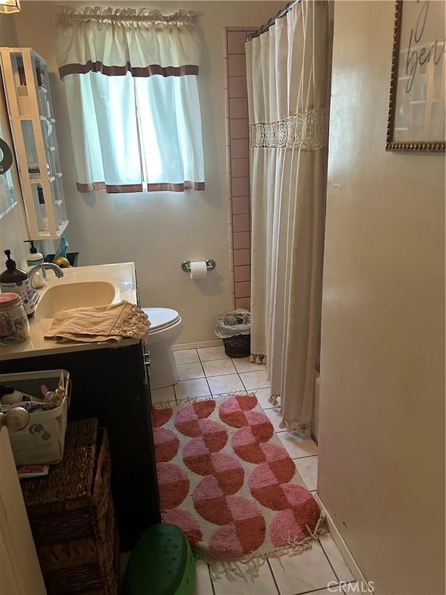 8900 Geyser Ave, Northridge, CA 91324 - bathroom featuring toilet, vanity, tile patterned floors, and shower / bath combination with curtain