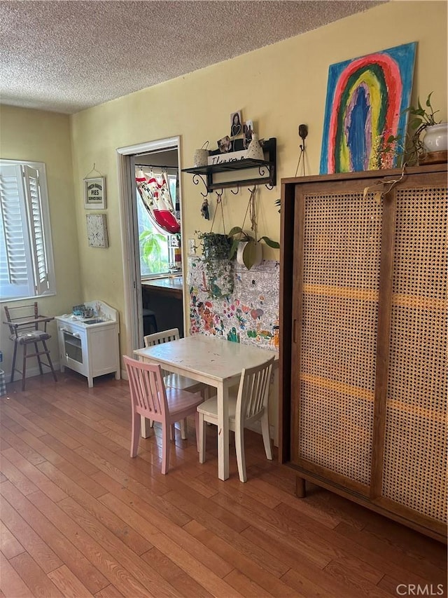 8900 Geyser Ave, Northridge, CA 91324 - dining space featuring hardwood / wood-style flooring and a textured ceiling