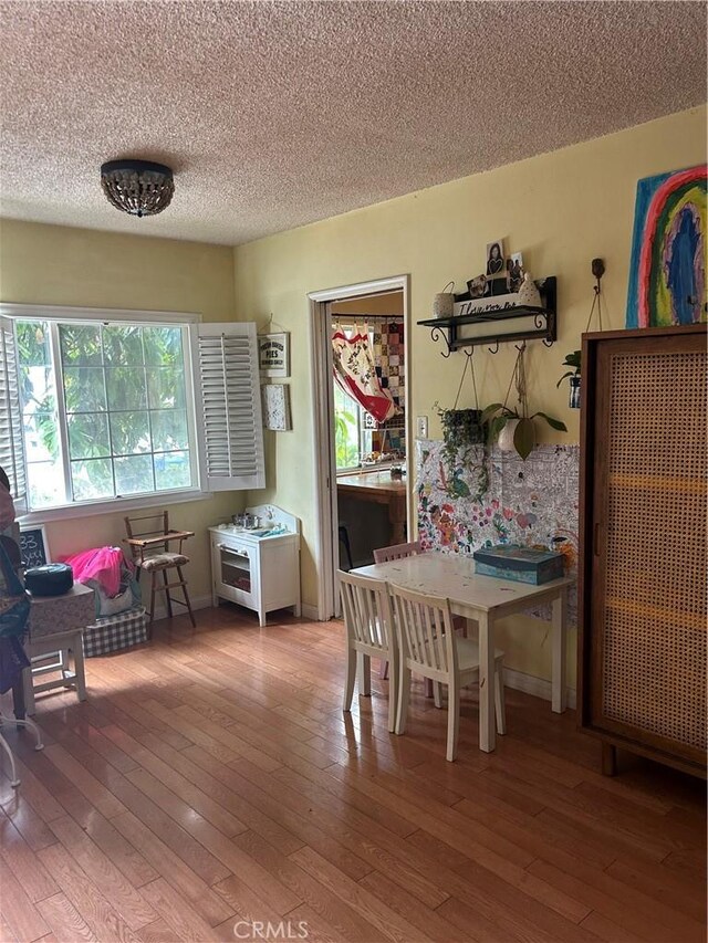 8900 Geyser Ave, Northridge, CA 91324 - dining space with hardwood / wood-style flooring and a textured ceiling