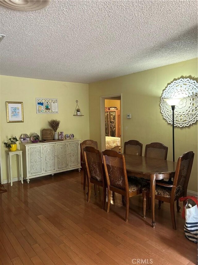 8900 Geyser Ave, Northridge, CA 91324 - dining space featuring dark wood-style floors and a textured ceiling