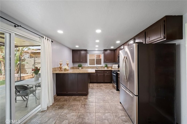 11396 Burl Dr, Fontana, CA 92337 - kitchen featuring appliances with stainless steel finishes, dark brown cabinetry, recessed lighting, a peninsula, and a sink