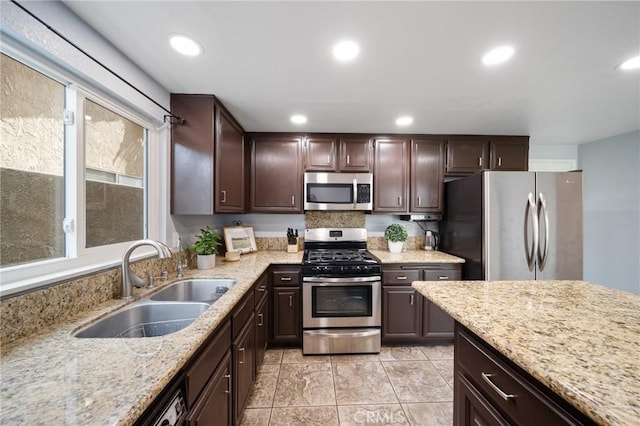 11396 Burl Dr, Fontana, CA 92337 - kitchen featuring appliances with stainless steel finishes, a sink, dark brown cabinets, recessed lighting, and light stone counters