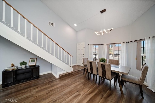 11396 Burl Dr, Fontana, CA 92337 - dining area featuring high vaulted ceiling, a chandelier, stairs, wood finished floors, and baseboards