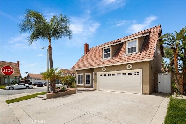 11396 Burl Dr, Fontana, CA 92337 - view of front of home with stucco siding, driveway, a chimney, a tile roof, and a garage