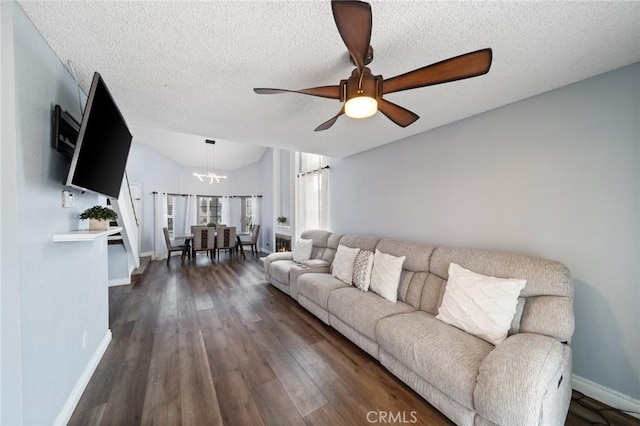 11396 Burl Dr, Fontana, CA 92337 - living room featuring a chandelier, baseboards, a ceiling fan, a textured ceiling, and dark wood-type flooring
