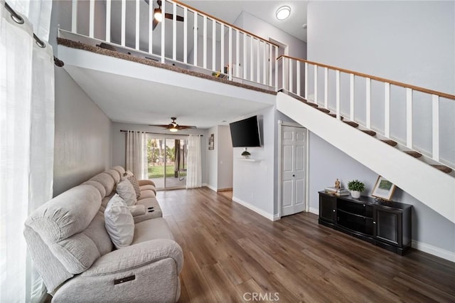 11396 Burl Dr, Fontana, CA 92337 - living area featuring wood finished floors, stairway, baseboards, a towering ceiling, and ceiling fan