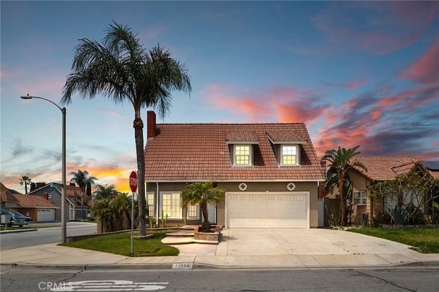 11396 Burl Dr, Fontana, CA 92337 - view of front facade with a tiled roof, driveway, a chimney, and stucco siding