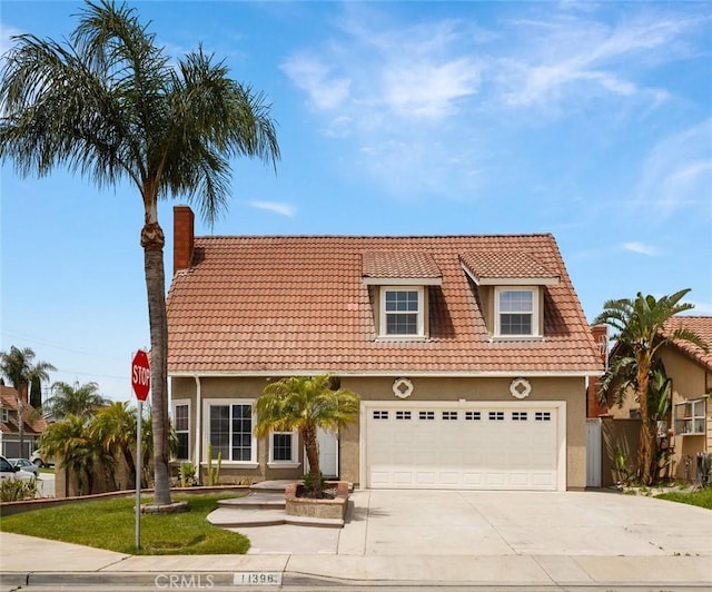 11396 Burl Dr, Fontana, CA 92337 - view of front facade featuring a tile roof, stucco siding, concrete driveway, and a chimney