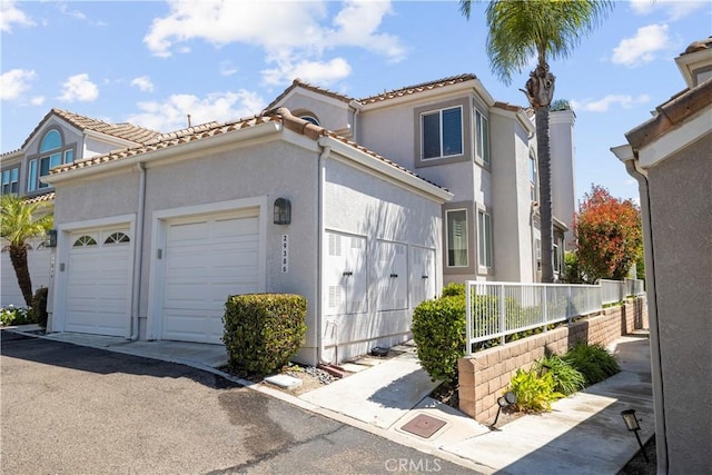 29386 Via Napoli, Laguna Niguel, CA 92677 - view of front facade featuring a garage, stucco siding, and a tiled roof