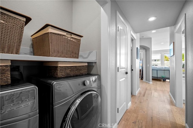 29386 Via Napoli, Laguna Niguel, CA 92677 - laundry area with light wood-style flooring, recessed lighting, baseboards, washing machine and clothes dryer, and a textured wall