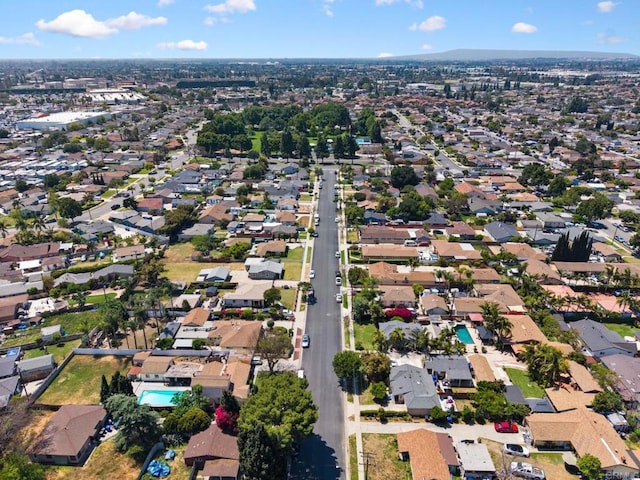 aerial view of property and surrounding area with nearby suburban area