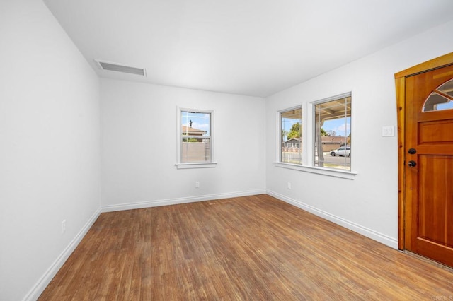 foyer entrance featuring wood finished floors and baseboards