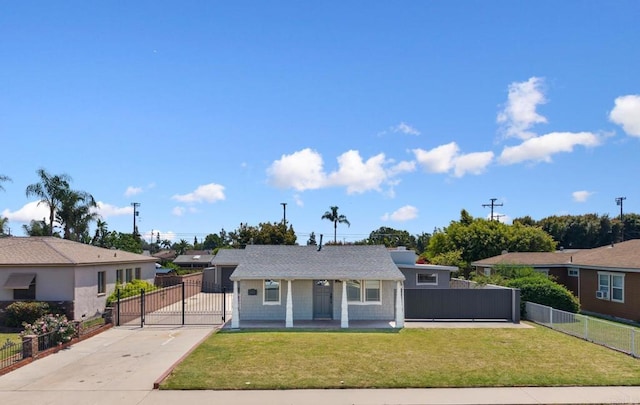 view of front of home featuring driveway, a gate, and covered porch