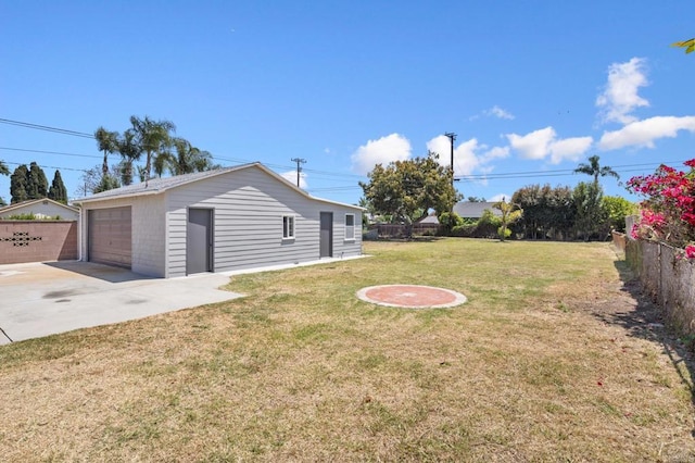 view of yard featuring a garage and an outbuilding