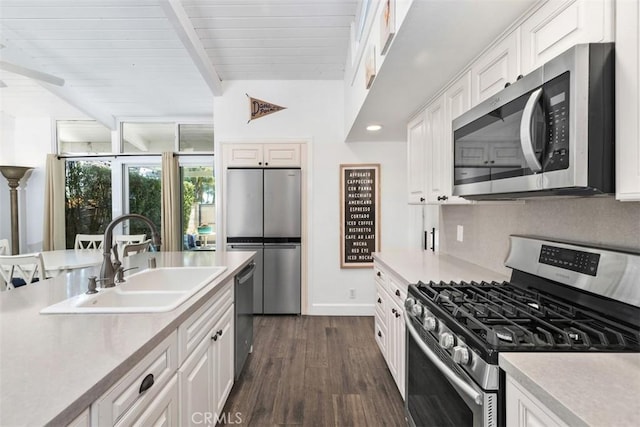 33926 La Serena Dr Unit 7, Dana Point, CA 92629 - kitchen featuring stainless steel appliances, a sink, beam ceiling, dark wood-style flooring, and white cabinets