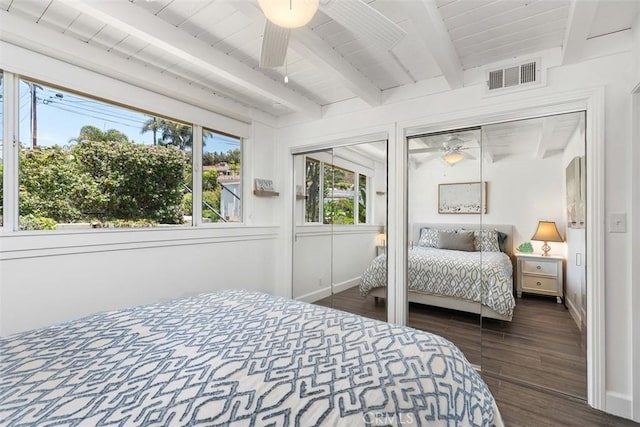33926 La Serena Dr Unit 7, Dana Point, CA 92629 - bedroom with two closets, dark wood-style floors, baseboards, and wooden ceiling with exposed beams
