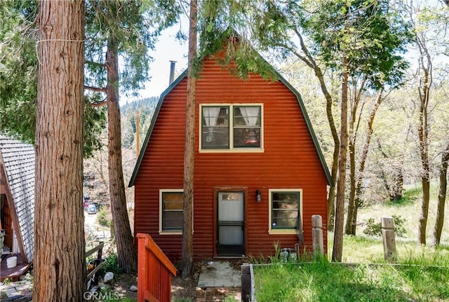 29219 Lyon Dr, Cedar Glen, CA 92321 - view of front of home featuring a gambrel roof, log veneer siding, and a chimney