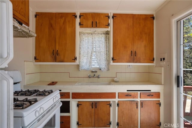 29219 Lyon Dr, Cedar Glen, CA 92321 - kitchen featuring white gas range, a sink, under cabinet range hood, and tile countertops