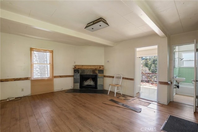 29219 Lyon Dr, Cedar Glen, CA 92321 - living area featuring hardwood / wood-style floors, a fireplace, a wainscoted wall, and beam ceiling