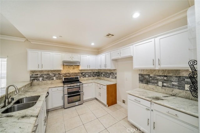 7404 Marshall Ct, Highland, CA 92346 - kitchen with range with two ovens, a sink, light stone countertops, light tile patterned floors, and white cabinets