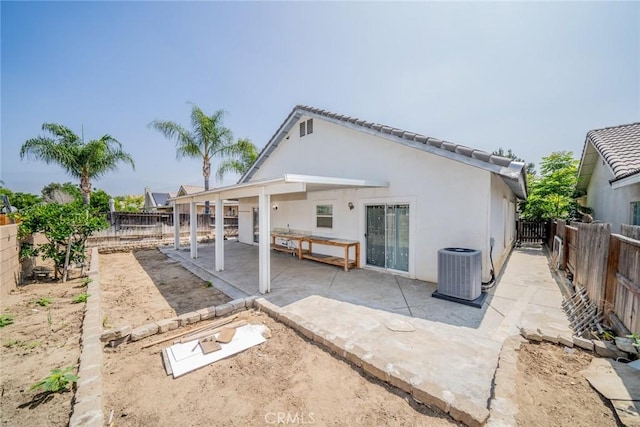 7404 Marshall Ct, Highland, CA 92346 - back of property featuring central AC, a fenced backyard, stucco siding, and a patio