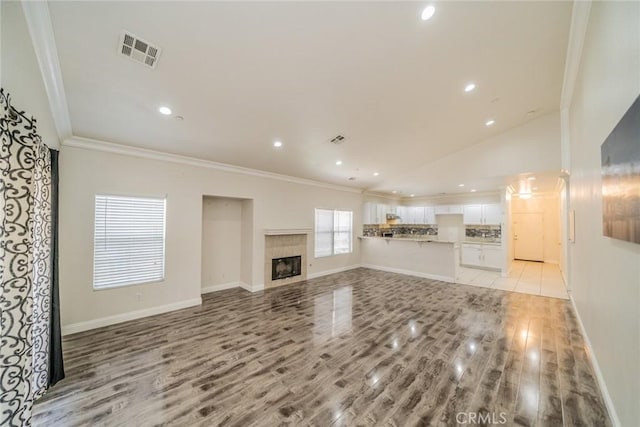 7404 Marshall Ct, Highland, CA 92346 - unfurnished living room featuring crown molding, light wood finished floors, baseboards, recessed lighting, and lofted ceiling