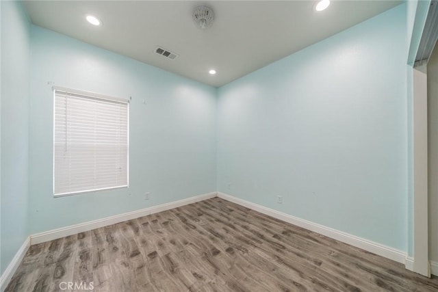 7404 Marshall Ct, Highland, CA 92346 - unfurnished room with wood finished floors, baseboards, and recessed lighting