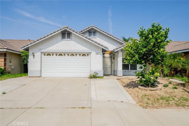 7404 Marshall Ct, Highland, CA 92346 - ranch-style home featuring concrete driveway, stucco siding, a garage, and a tile roof