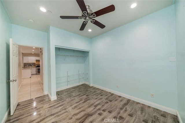 7404 Marshall Ct, Highland, CA 92346 - unfurnished bedroom featuring light wood-style floors, recessed lighting, a closet, baseboards, and ceiling fan