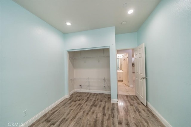 7404 Marshall Ct, Highland, CA 92346 - washroom with wood finished floors, baseboards, and recessed lighting